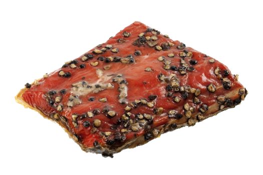a piece of wild caught, smoked and peppered sockeye salmon isolated on white 