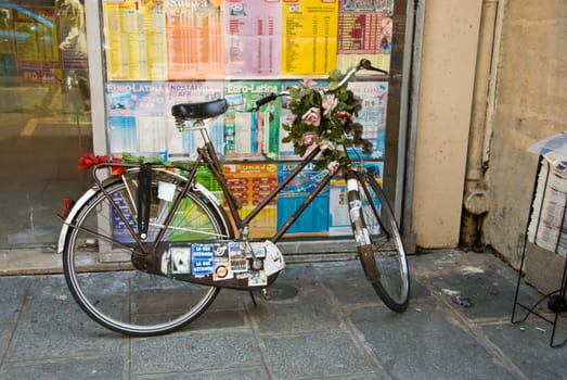 sticker covered bicycle with roses in Paris, France