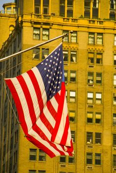 American flag and high rise building