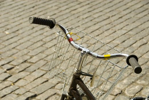 bicycle and wire basket on brick street