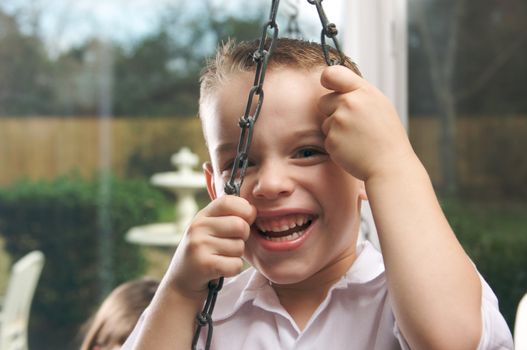 Adorable Young Boy with Blue Eyes Smiles for the Camera