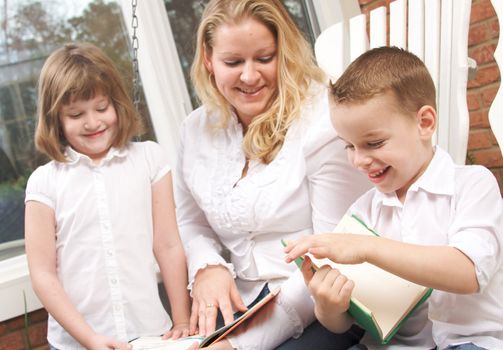 Young Boy Reads to His Mother and Sister