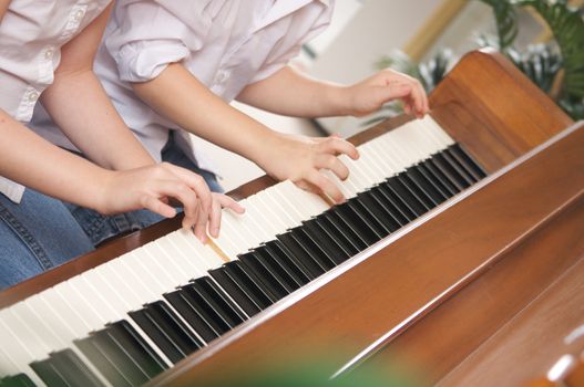 Brother and Sister Playing the Piano Together