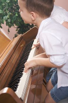 Brother and Sister Playing the Piano Together