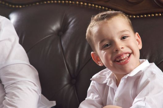 Adorable Young Boy with Blue Eyes Smiles for the Camera