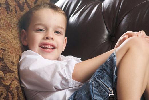 Adorable Young Boy with Blue Eyes Smiles for the Camera