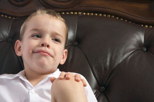 Adorable Young Boy with Blue Eyes Smiles for the Camera