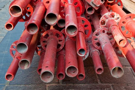 Red pipes on Bruges sidewalk