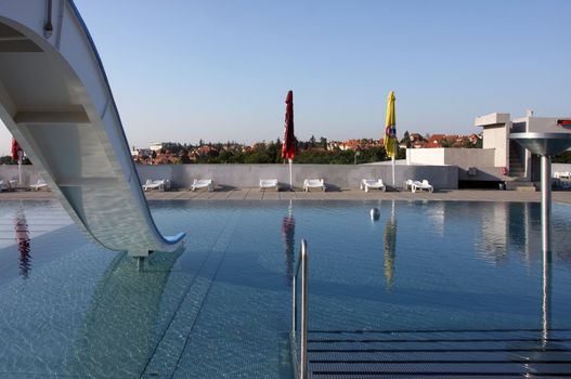 Dispeopled bath pool with white slide