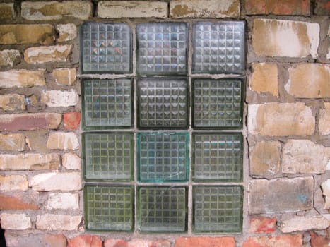 Old window in a brick wall from glass blocks.