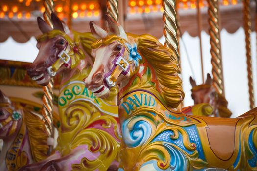 A colorful wooden horse on a carousel ride