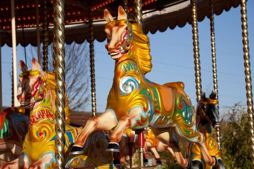 A colorful wooden horse on a carousel ride