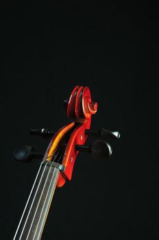 detail of cello on black background