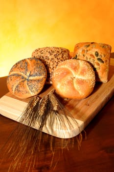 Sandwiches in cereals, wheat ears on the table dark wood