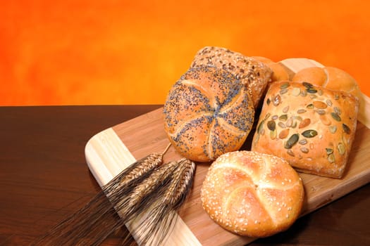 Sandwiches in cereals, wheat ears on the table dark wood