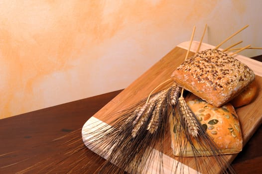 Sandwiches in cereals, wheat ears on the table dark wood