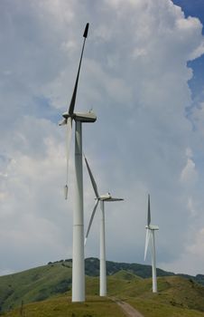 Three wind turbines atop a mountain