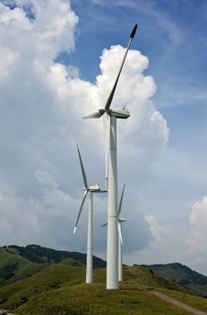  
Three wind turbines a top a mountain