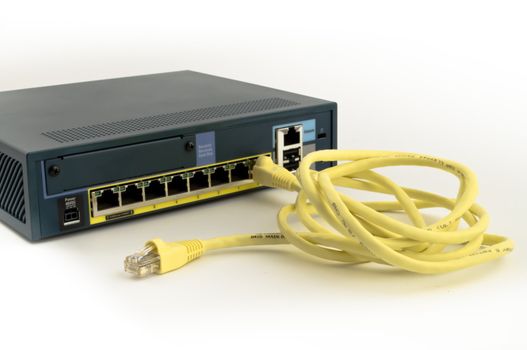 Ethernet firewall with yellow cable isolated on white