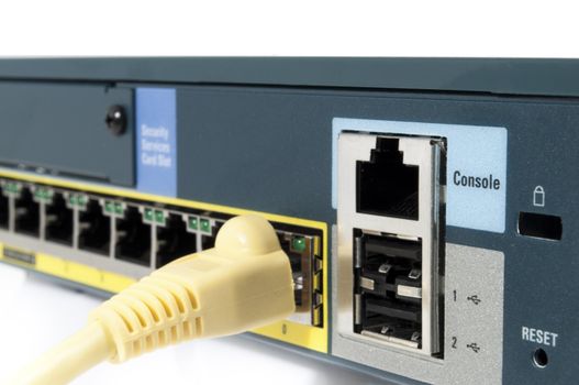 Yellow cable plugged in an ehternet firewall