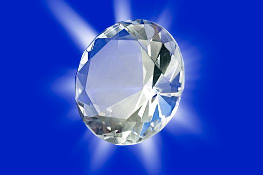 A photo of a diamond on a blue background with starburst