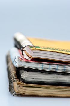 stack of ring bound notebook on white background