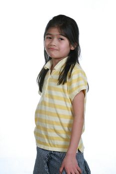 Seven year old girl standing with slight attitude. Part Thai - Scandinavian descent.