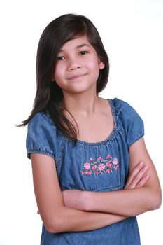 Confident Nine year old girl  smiling with arms crossed. Part Asian-Scandinavian descent