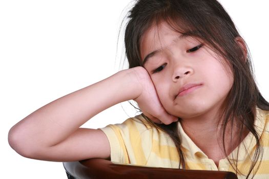 Sad girl sitting on chair, part Asian-Scandinavian descent