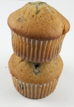 Two blueberry muffins stacked.