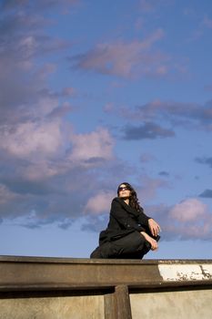 Pretty Hispanic woman with dark sunglasses in an urban setting