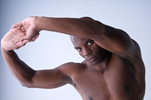 A young african american stretching before an exercise routine.