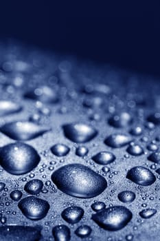water drops on silver metal surface 