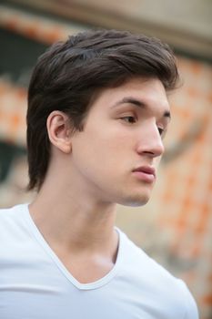 close-up portrait of the dark-haired guy in white t-shirt