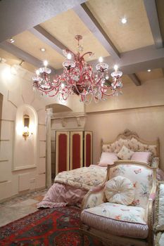 Interior to luxurious bedroom in rococo style, expensive furniture