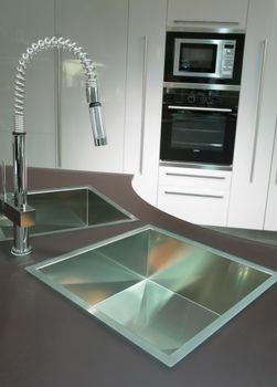 modern metallic sink with graceful tap on the super-modern kitchen