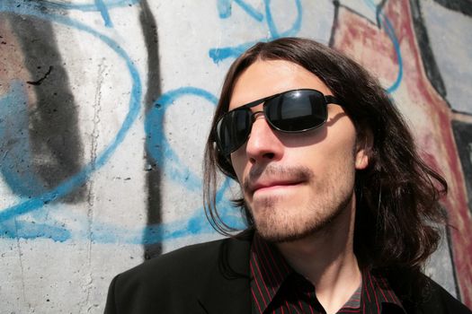 close-up portrait of the young man in black sunglasses in gangster style