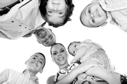 A happy family posing in a group huddle formation with a unique perspective.