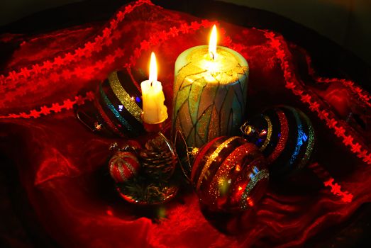 christmas collage with burning candles, decorative balls and glass
