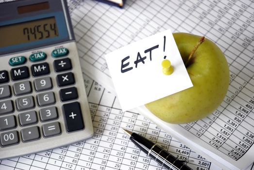 eat reminder on apple among papers and calculator