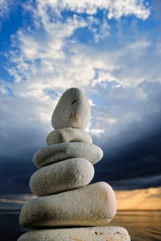 The stack of the pebbles on the background of the dark sky