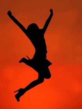 silhouette of a happy woman jumping
