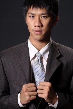 Handsome businessman of young, closeup portrait of Asian in studio.