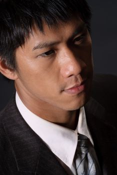 Closeup portrait of young business man, handsome Asian guy with lonely face.