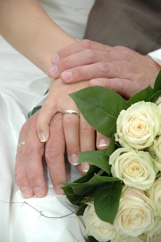 Wedding couple holding hands and a bouquet