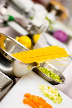 italian spaghetti pasta on a typical full equipped restaurant kitchen