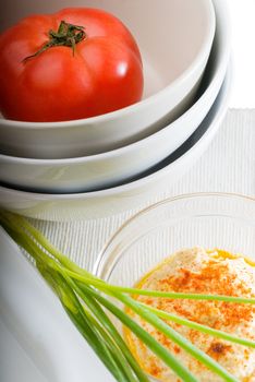 fresh healthy hummus with tomato and chives  typical middle east dish