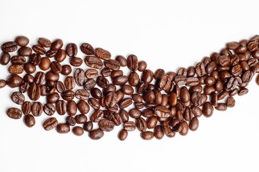 bounch of roasted coffee beans mimic a road shape