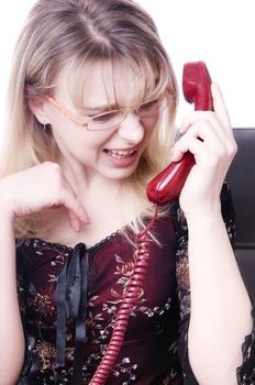 Portrait of secretary screaming in telephone receiver on working day