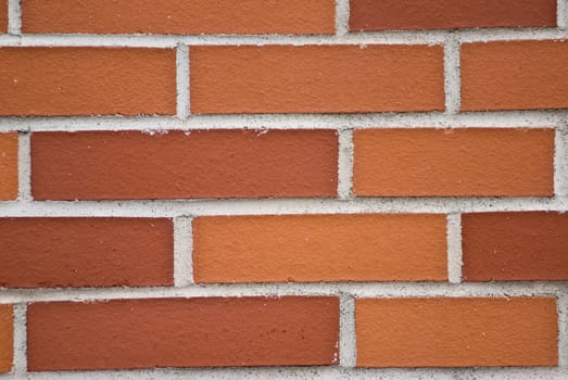 a brickwall with stones in shades of red and orange